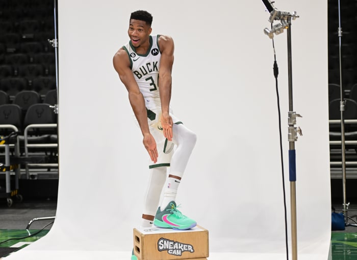 Giannis Antetokounmpo points to his Nike Zoom Freak 4 shoes.